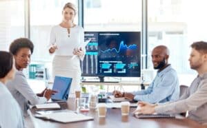 femme trader analysant des graphiques boursiers sur un écran